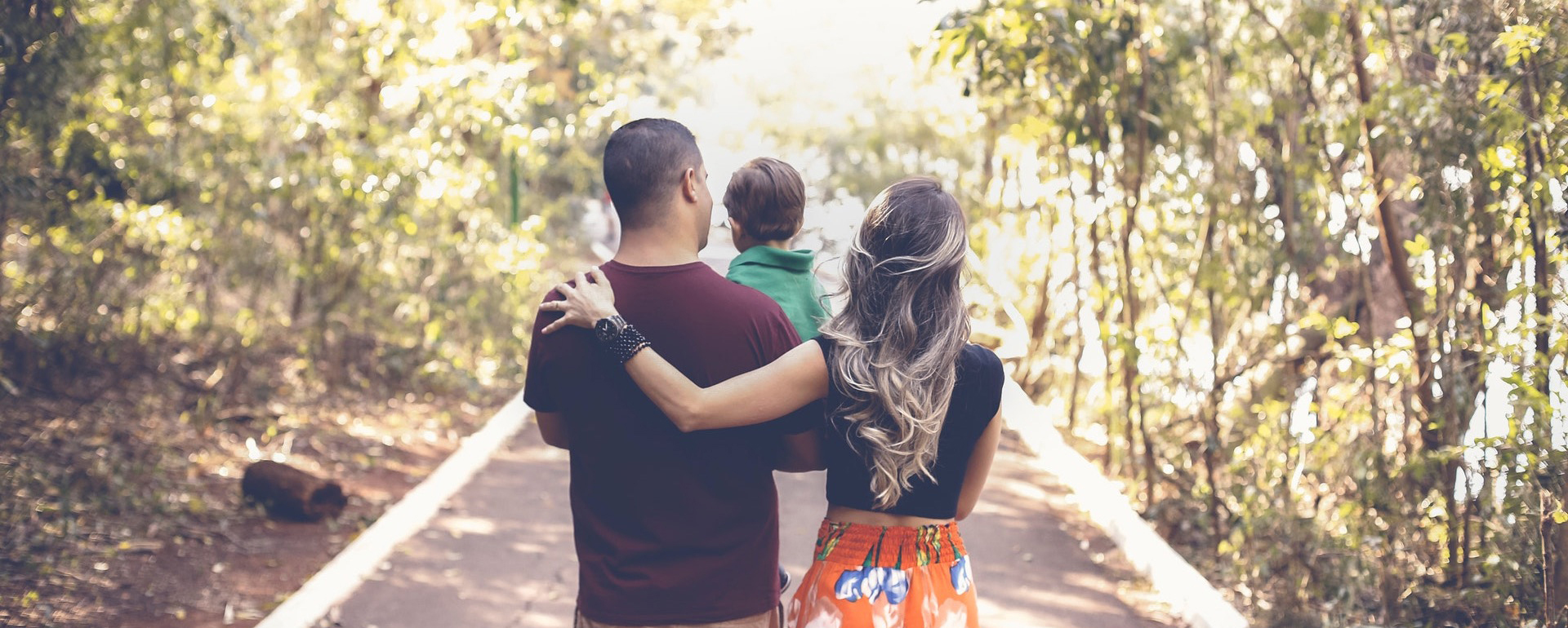 a healthy family walks down a path