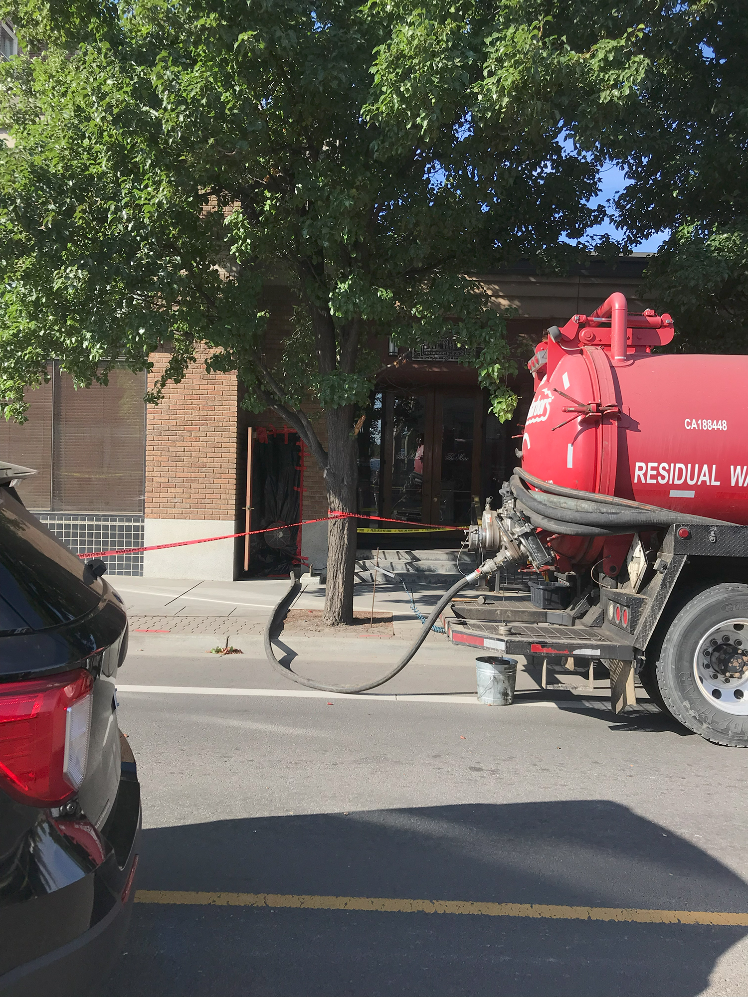 Pumping equipment on a frac truck with a hose leading into the Marcus Whitman Hotel