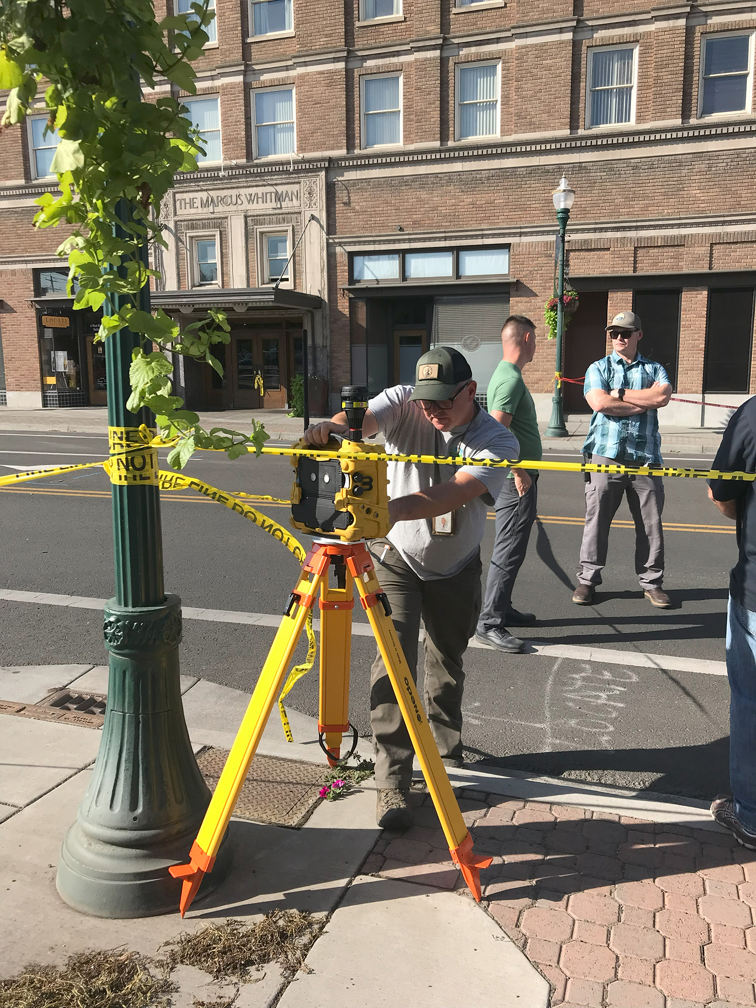 An official from the DOE adjusts an air-quality monitor on 2nd Avenue