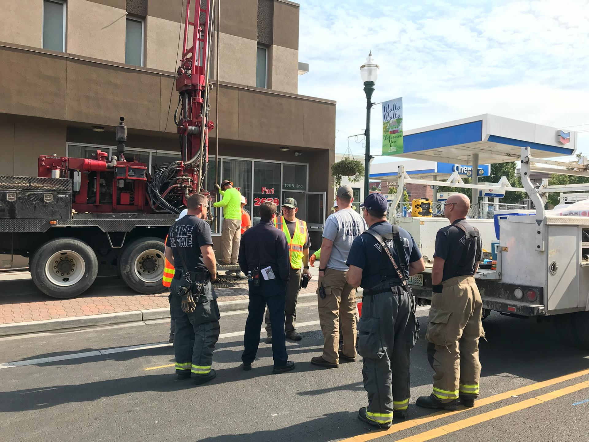 Members of the response team discuss the current drilling work on 2nd Avenue, on Sept. 23, 2023.