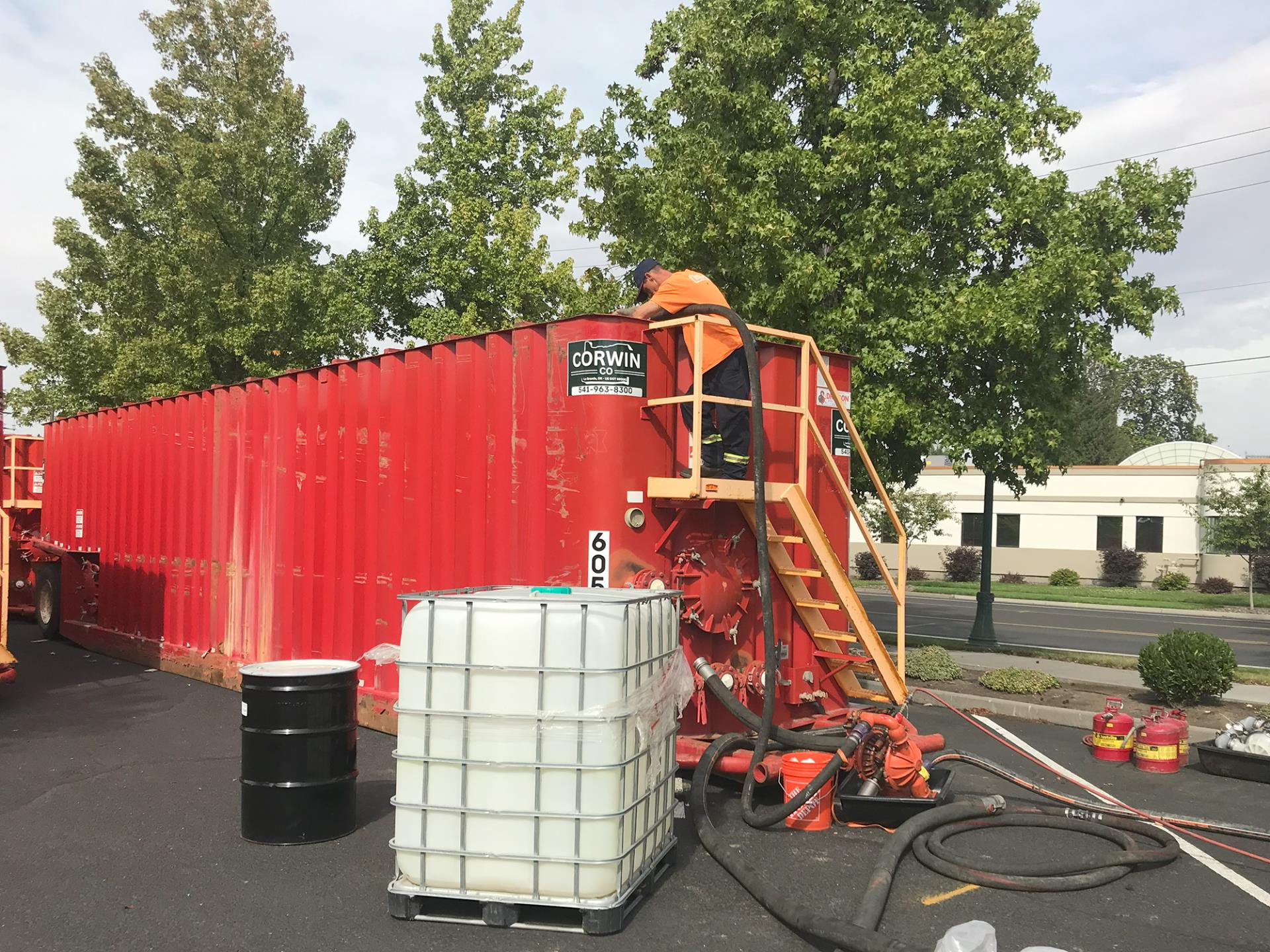 Contaminants are pumped from a hose into a frac tank, on Sept. 25, 2023.