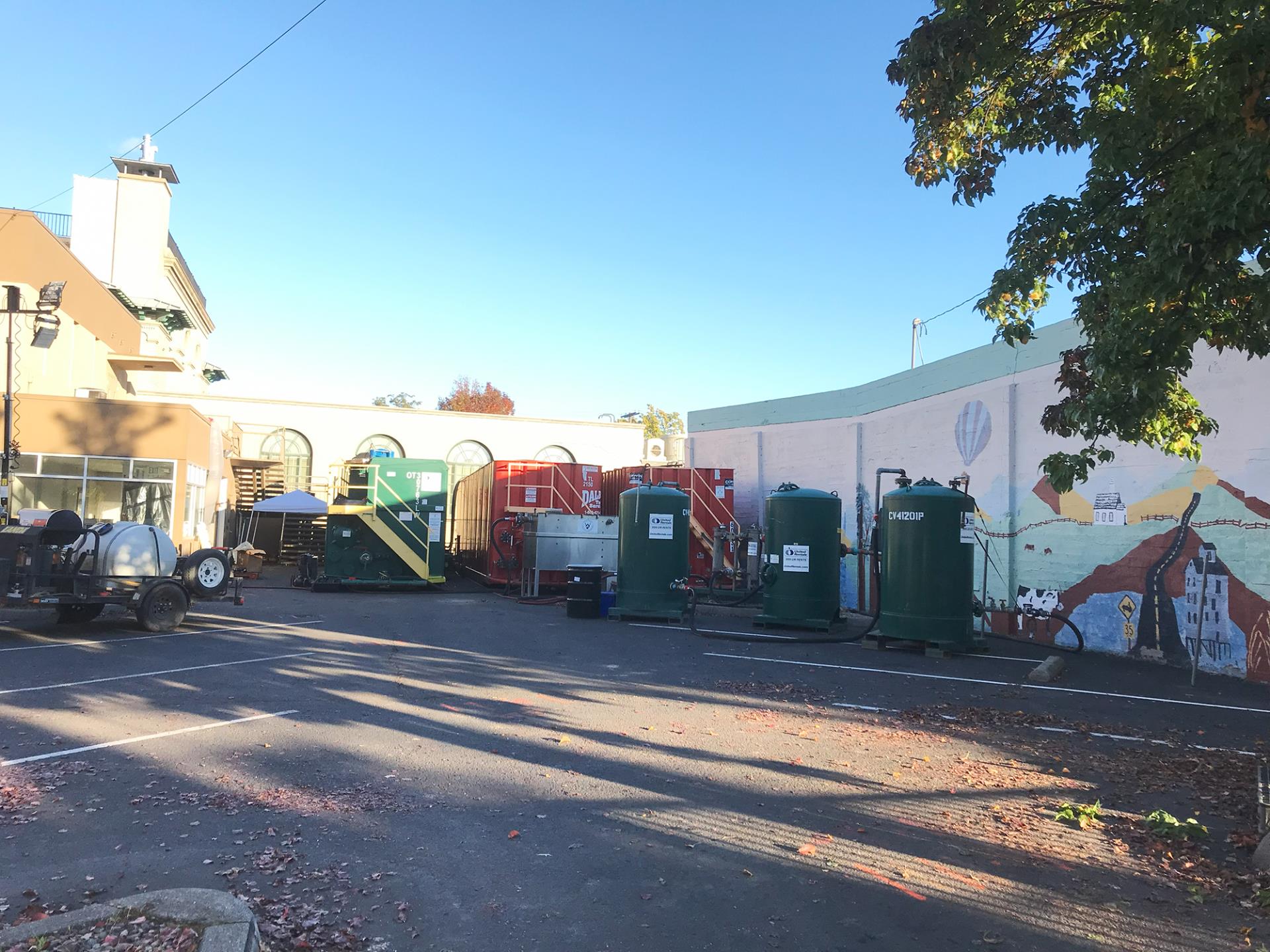 The parking lot of 106 N. 2nd Ave. with frac tanks and other response equipment, on Oct. 18, 2023.