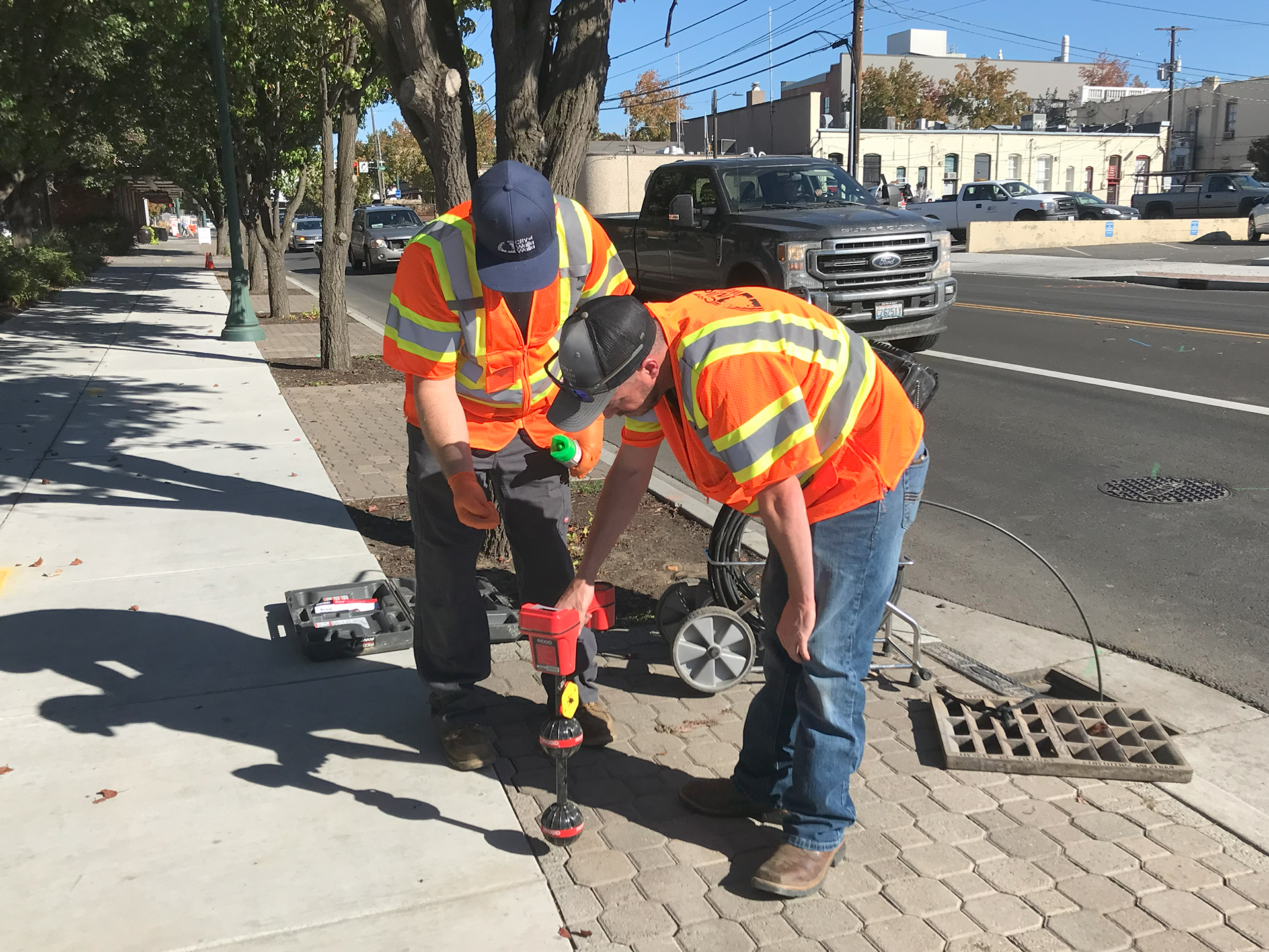 City of Walla Walla Street Division staff work to locate the route of a pipe leading to the storm drain near 3rd and Rose, on Oct. 19, 2023.