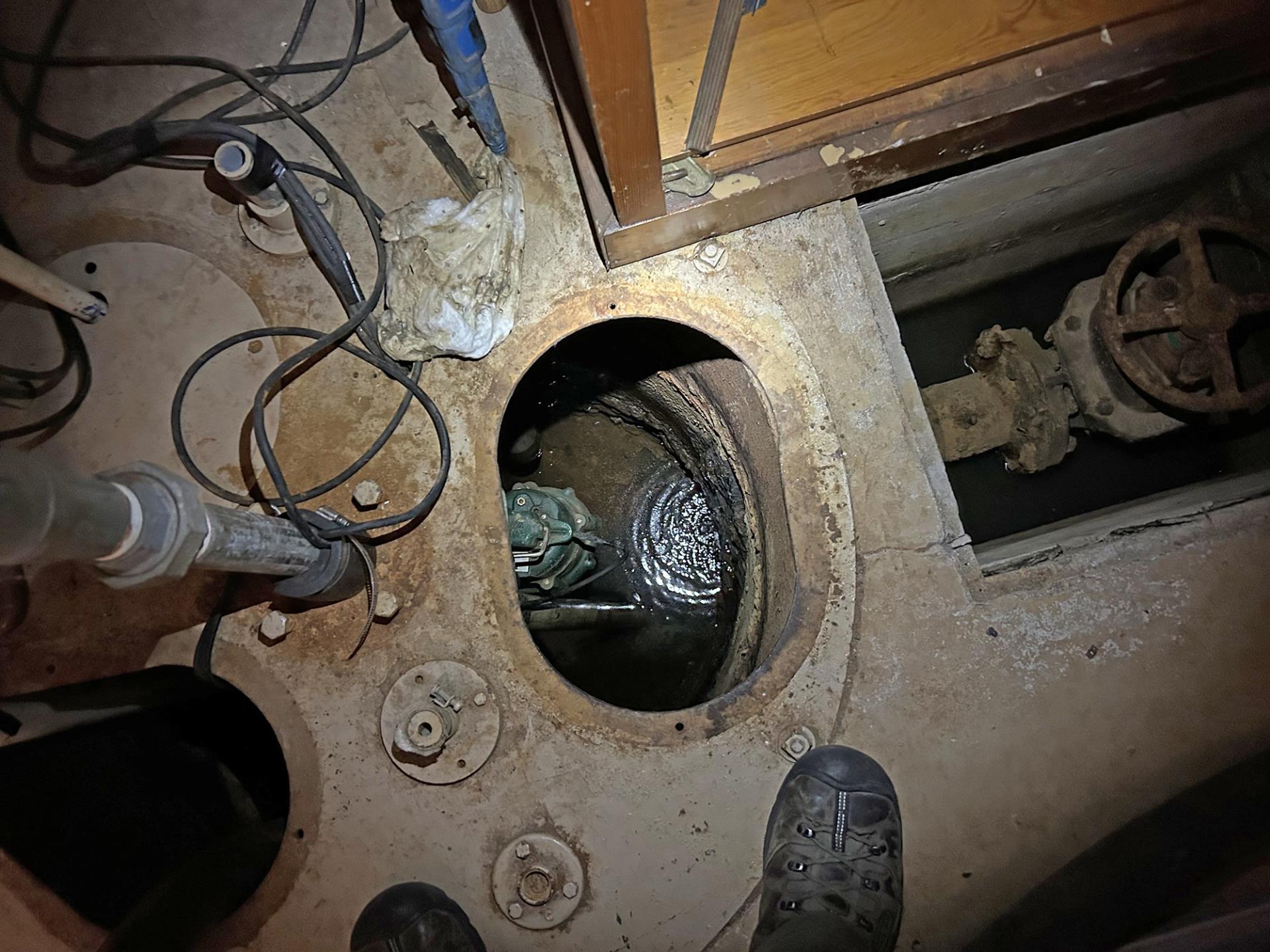 The groundwater sump in the basement of the 106 building, which continues to actively fill with water and visible product.